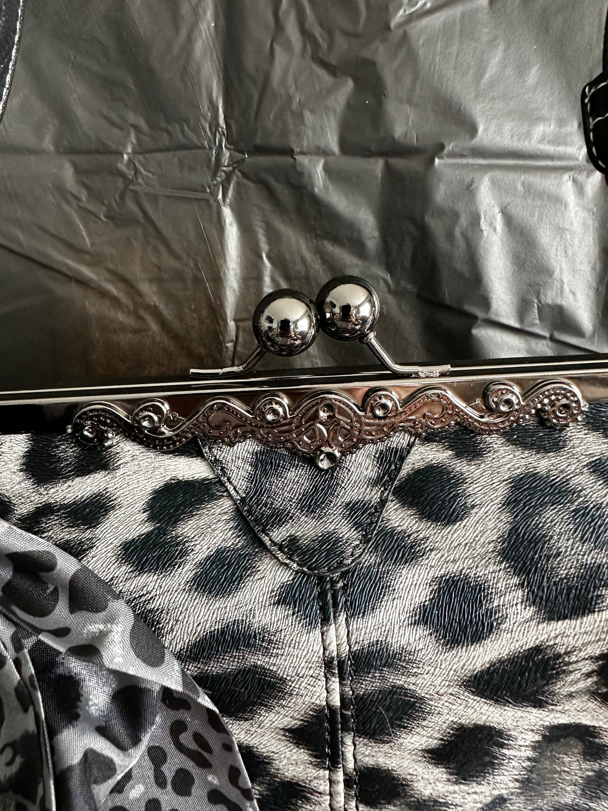 Close-up of leopard-print bow and combined decorative charms