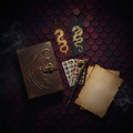 4th Wing inspired journal kit flat lay with dragon motifs, bookmarks, journal, stickers and pen on dark burgundy background