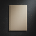 Lightweight blank paper journal with perfect bound spine on dark moody surface
